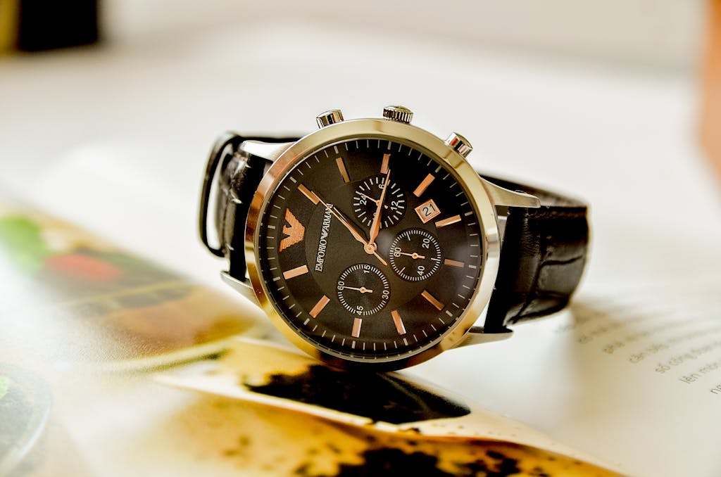 Close-up of a stylish Emporio Armani watch resting on an open book, showcasing luxury and elegance.